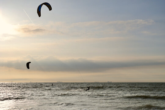 Kitesurfing in the evening at a Dutch beach on a windy spring day. The north sea near Wassenaar, The Netherlands. 
