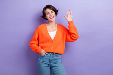 Photo of satisfied adorable girl arm palm waving hi toothy smile isolated on violet color background © deagreez