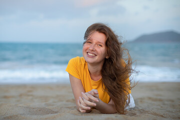 Portrait of happy girl, young carefree woman enjoying summer vacation on sea, walking on beach sand, smiling and having fun in tropical country, relaxing on nature. Summertime, happiness concept.