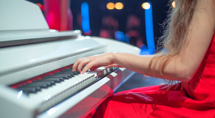 girl at the piano on stage
