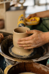 In the pottery workshop the potter dries the finished clay jug with a dryer