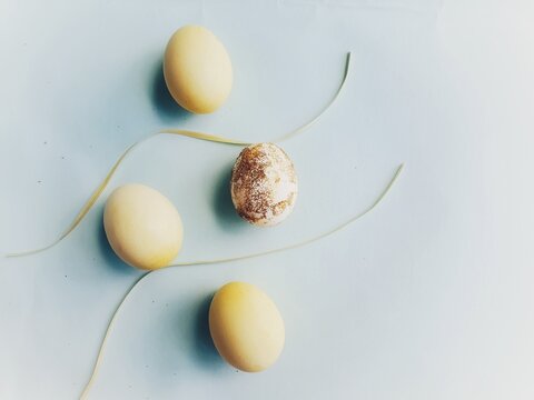 yellow eggs representing easter and with ribbons and blue background