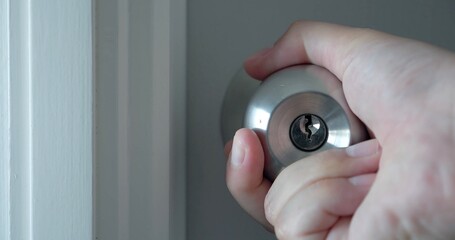 Close up of hand open the door knobs of white door. Man hand open door knob