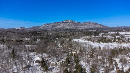 Aerial view of the Canadian countryside in Quebec near a maple grove in spring.