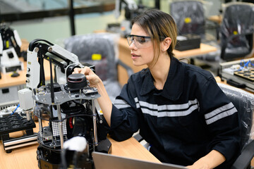 Fototapeta na wymiar Female technician engineer using laptop checking automatic robotic machine