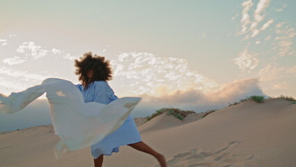 Dancer performance fluttering cloth in desert summer haze. Woman dancing modern.