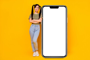 Full body photo of young pretty girl lean on big smartphone device gadget isolated on yellow color background