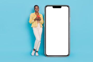 Full length body size view of beautiful trendy girl using gadget copy space promo ad isolated on bright blue color background