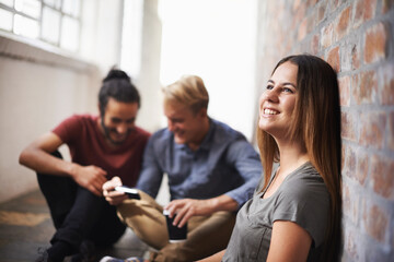 Relaxing before the next class. students relaxing in a hallway.