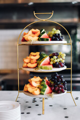Assorted fruits on three-tiered cake stand