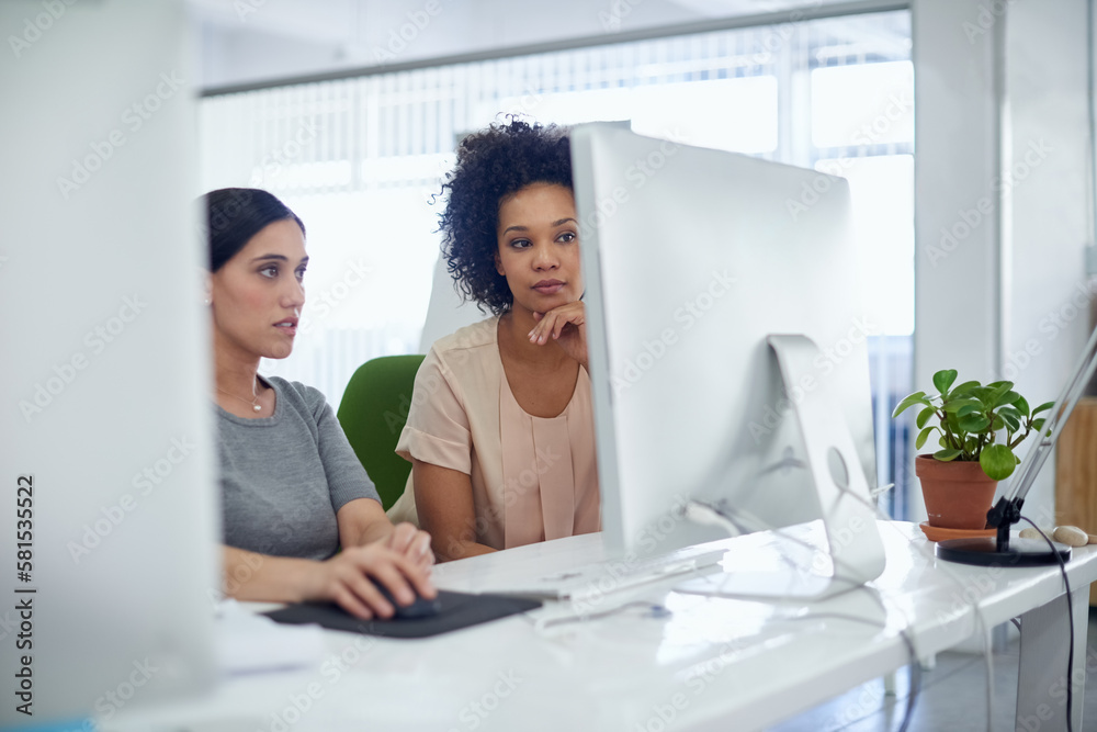 Poster on the right track to success. two creative businesspeople working together on a computer in the off