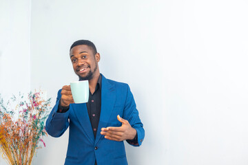 Portrait of Happy mood african young businessman working holding a coffee cup wear a business suit