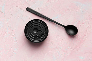 Tin can and spoon on texture background top view