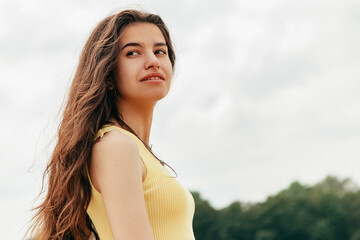 Slim woman walking barefoot along the river sea lake. Female on beach island with splashing waves and foam. Girl tourist on vacation, weekend relaxing resting resort. Lady go on shore, sunbathing
