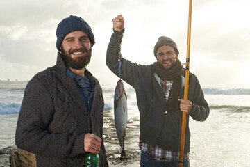 That awkward smile when you didnt catch anything. two young men fishing at the ocean.