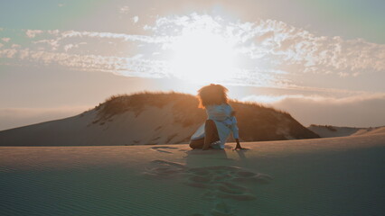 Silhouette woman dancing sunset in desert. Girl performing emotional dance.
