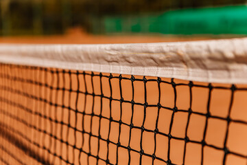 Light orange empty outdoor clay court surface dry grungy ground baseline detail for playing tennis...