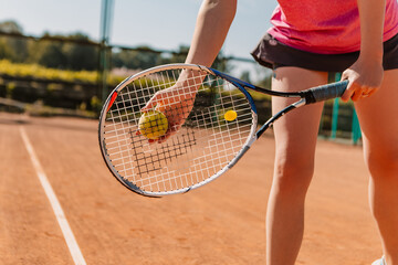 Caucasian european woman hold yellow green ball, playing tennis match on clay court surface on weekend, wear skort. Female player ready to serve. Professional sport concept
 - obrazy, fototapety, plakaty