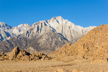 off-roading in the Alabama hills with the snow capped eastern sierra nevada mountains in the background.