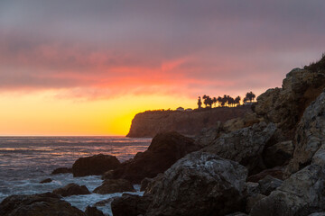 Fototapeta na wymiar Sunsetting behind the lighthouse in palos verdes in Los Angeles