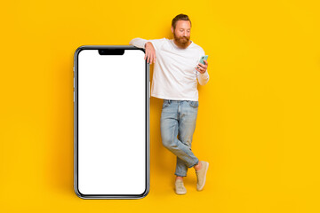 Full body photo of beard man look telephone wear shirt jeans shoes isolated on yellow color background