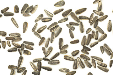 Sunflower seeds in shell spilled on white background. Wallpaper texture
