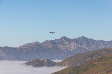 Clouds rolling into the mountains like an ocean tide and big bird flying over. Pictures taken in Ojai, California, outside of Los Angeles.