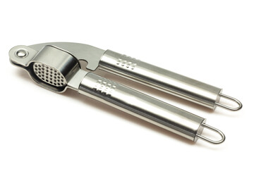 Metallic shiny garlic press crusher tool isolated on white background. Stainless kitchen utensil mincer