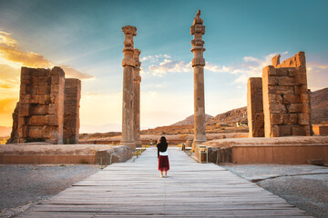 Tourist walk explore sightseeing famous destination - Persepolis ancient - persian city in south Iran. Famous travel destination in middle east - obrazy, fototapety, plakaty