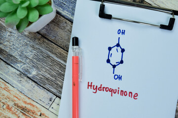 Concept of Hydroquinone write on paperwork, structural chemical formula isolated on Wooden Table.