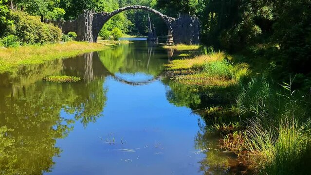 Long, revealing vertical shot of Rakotzbr&uuml;cke Devil's Bridge in Gablenz, Germany.