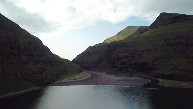 The drone shot of black beach near Saksun village in Faroe Islands.