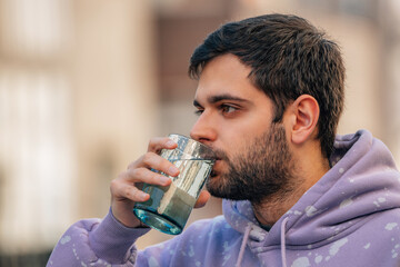 young man drinking glass of water