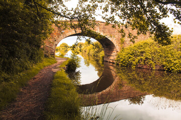A beautiful scenic and postcard shot of a bridge crossing over the Leeds to Liverpool Canal, the...