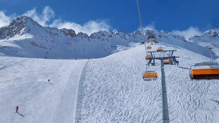 Ski lift and ski slope in a resort in the alps.