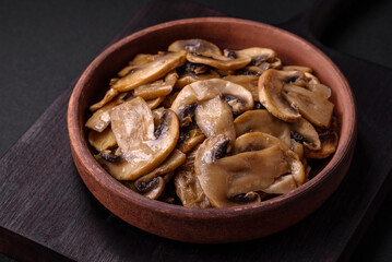 Fried or stewed champignon mushrooms in the form of slices with onions