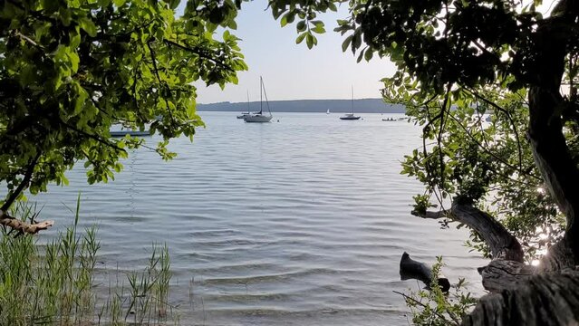 Beautiful calm lake with sailboats in Bavaria, Germany.