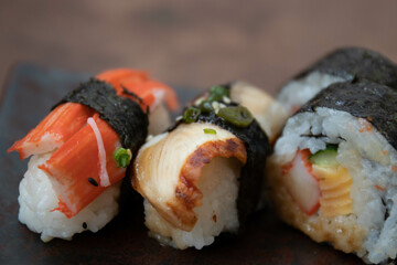 Mixed Japanese food, Sushi Roll, on black background