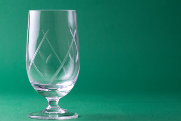 Cálice de cristal para licores e fundo verde