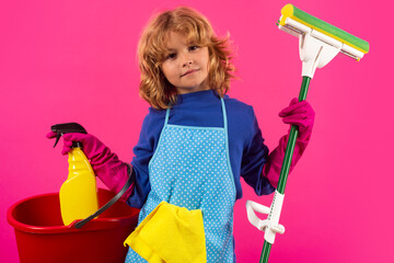 Child doing housework. Studio portrait of child use duster and gloves for cleaning. Funny child...