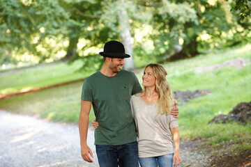 Fototapeta premium Loving every minute together. a young couple walking arm in arm in a park.