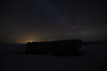 Amazing natural phenomenon called aurora borealis at the famous plane wreck in Iceland.