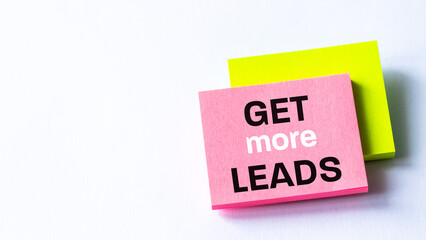 Get more leads, banner with text written on pink paper, white background, Positive business concept, copy space