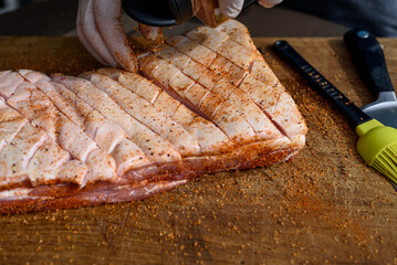 Meat preparation for BBQ.Pork belly  is a boneless and fatty cut of meat from the belly of a pig. Pork belly is particularly popular in Hispanic, Chinese, Danish, Norwegian, Korean, Thai and Filipino