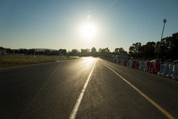 Road view of race track with some barrier tires.