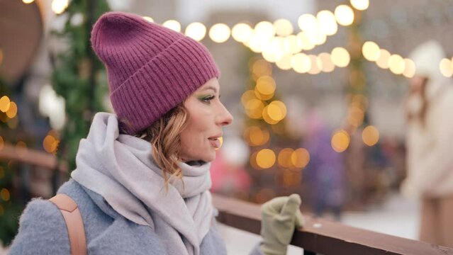 adult woman watching child on ice rink in winter day, portrait of middle aged lady, careful mother