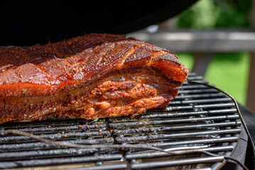 vSMOKER BBQ FILLED WITH MEAT.Pork belly or Belly Pork is a boneless and fatty cut of meat from the belly of a pig. Pork belly is particularly popular in Hispanic, Chinese, Danish, Norwegia