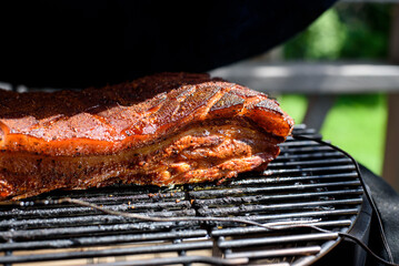 vSMOKER BBQ FILLED WITH MEAT.Pork belly or Belly Pork is a boneless and fatty cut of meat from the belly of a pig. Pork belly is particularly popular in Hispanic, Chinese, Danish, Norwegia