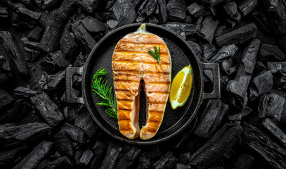 grilled salmon steak on BBQ grill coal. Long banner format. top view