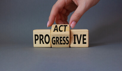 Proactive and Progressive symbol. Businessman hand turns wooden cubes and changes the word Progressive to Proactive. Beautiful grey background. Business concept. Copy space